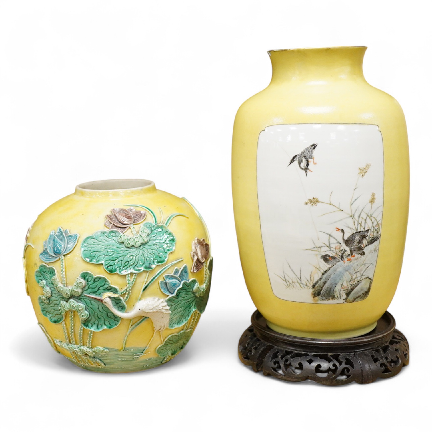 A Chinese yellow ground vase and carved hardwood stand and a Chinese sancai glazed jar, decorated in relief, both early 20th century, largest 25cm high